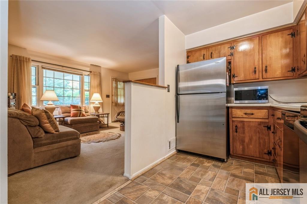 129 Cottrell Road Old Bridge, NJ 07747 - Photo 7 of 25 a kitchen with stainless steel appliances a refrigerator a stove a sink and a window