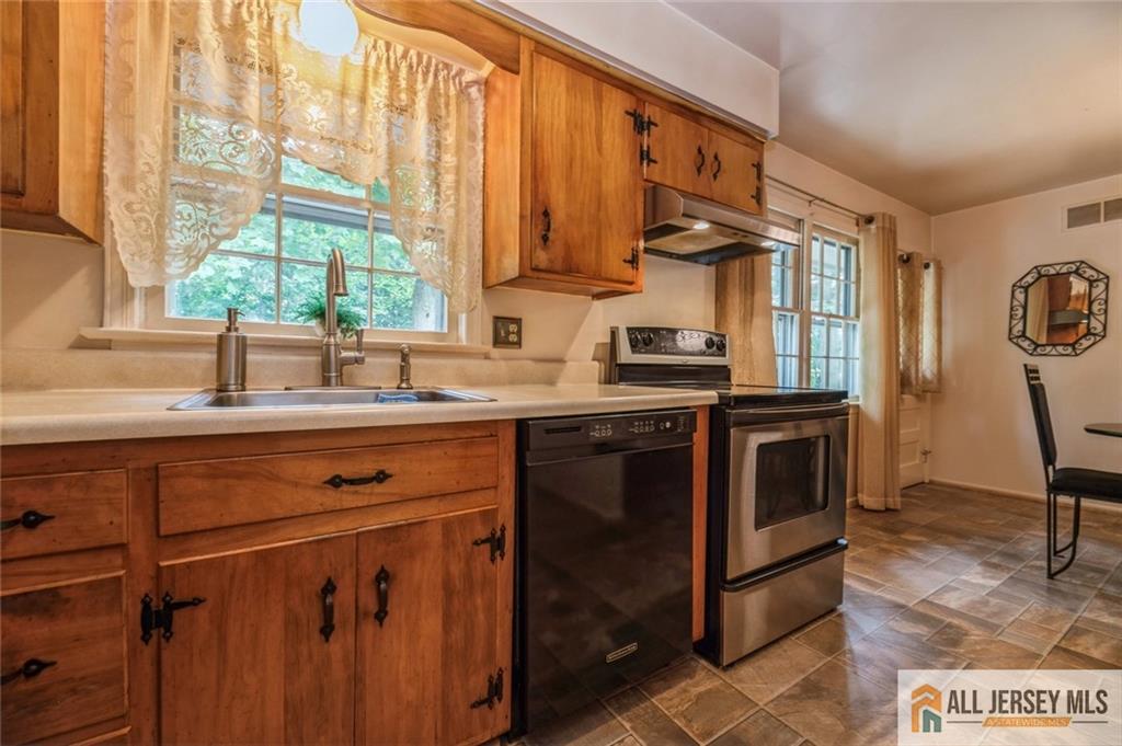 129 Cottrell Road Old Bridge, NJ 07747 - Photo 8 of 25 a kitchen with stainless steel appliances granite countertop a stove a sink and a microwave