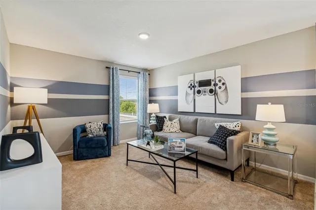 a bedroom with a bed and painting on the wall