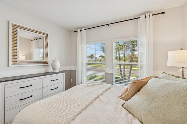 a living room with furniture and a painting on the wall