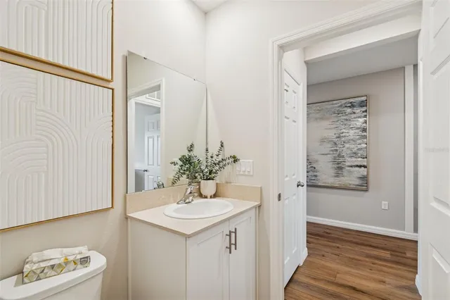 a bedroom with a bed and a painting on the wall