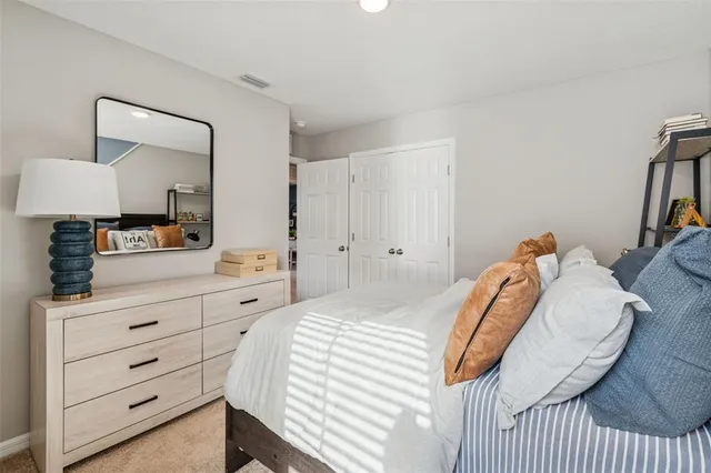 a en suite bathroom with a double vanity sink a mirror and a toilet