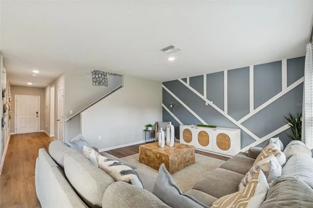 a living room with furniture and a potted plant