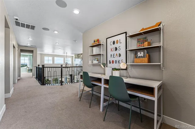 a spacious bedroom with a bed and ceiling fan