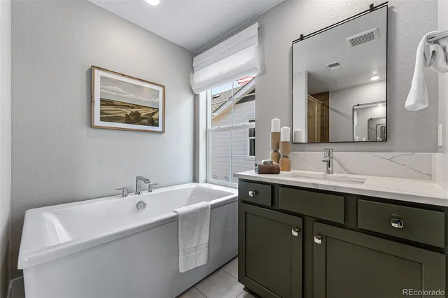 a view of walk in closet with clothes and white walls