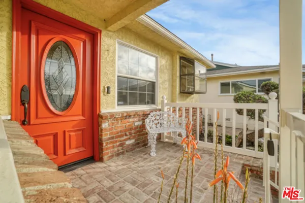 a view of a house with wooden fence and a porch