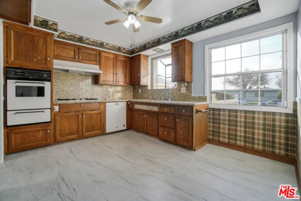 a kitchen with stainless steel appliances granite countertop a sink and cabinets