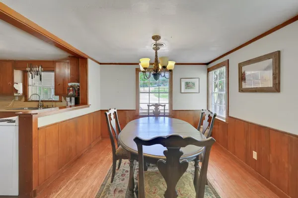 a large kitchen with kitchen island a dining table and chairs