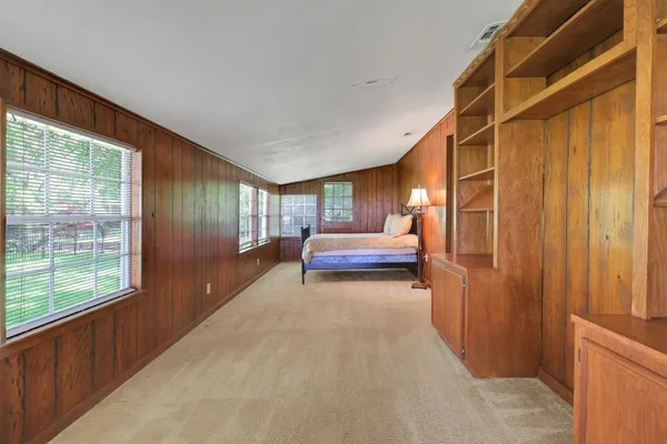 a bedroom with bed and window