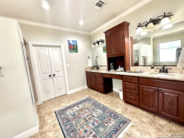a spacious bathroom with a granite countertop sink and a mirror