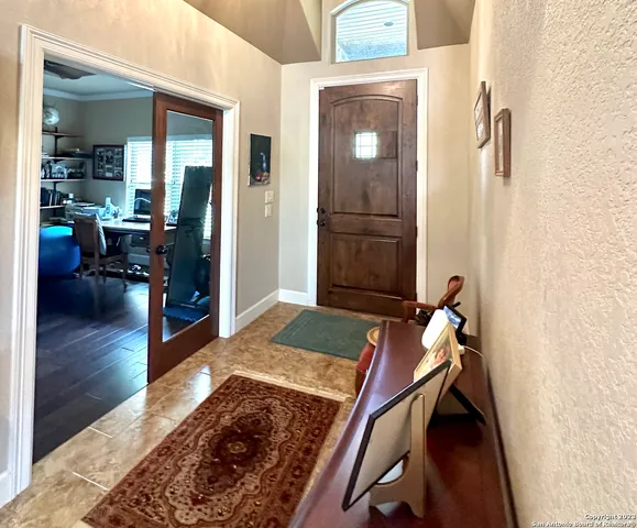 a living room with furniture rug and wooden floor