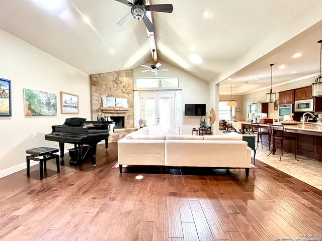 a living room with furniture and kitchen view