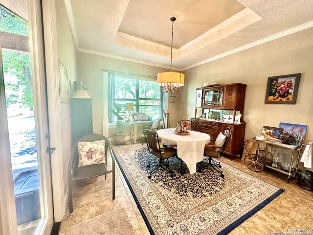 a living room with furniture a table and a chandelier