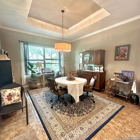 a living room with couch a table and a chandelier