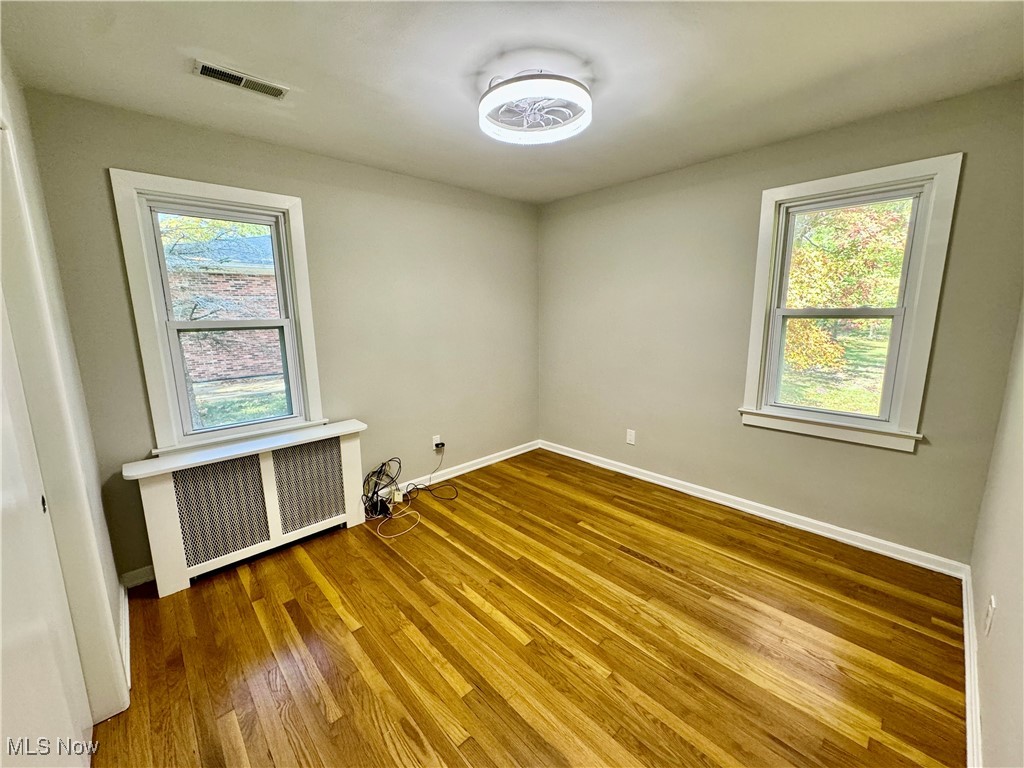 1729 East Pleasant Valley Road Independence, OH 44131 - Photo 23 of 41 Unfurnished room featuring radiator and wood-type flooring