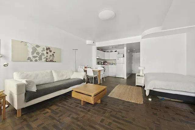 a bedroom with a bed and a couch