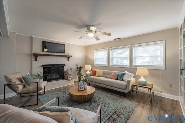 a living room with furniture a fireplace and a flat screen tv
