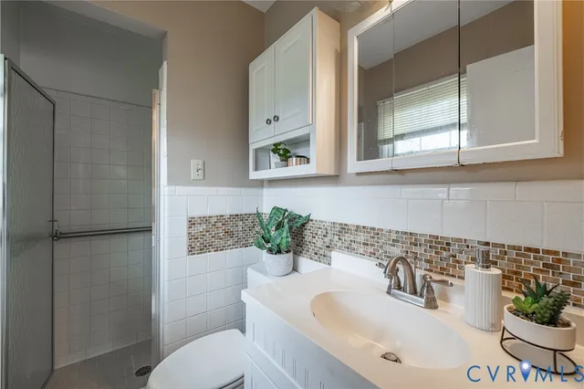 a bathroom with a sink toilet and mirror