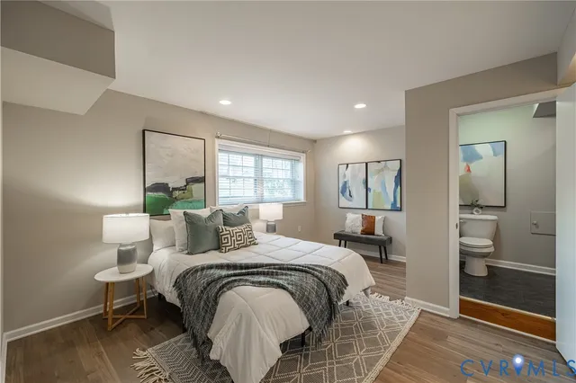 a bedroom with a large bed and a window