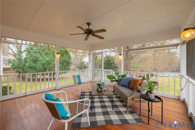 a very nice looking living room with a large window and a table
