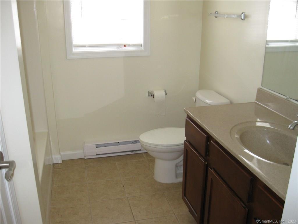 7 New Street, Unit 305 Danbury, CT 06810 - Photo 7 of 15 a bathroom with a sink a toilet and a window