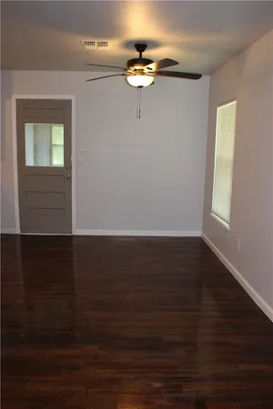 a view of a room with wooden floor and fan