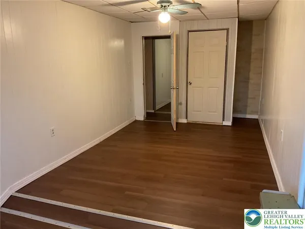 a view of an empty room with wooden floor