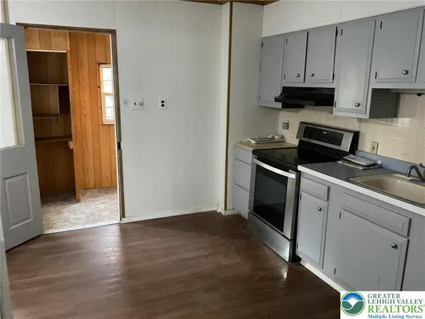 a kitchen with a sink and a refrigerator