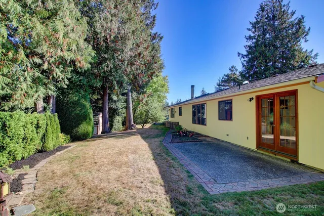 a backyard of a house with a garden and deck