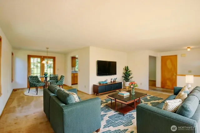 a living room with furniture and a flat screen tv