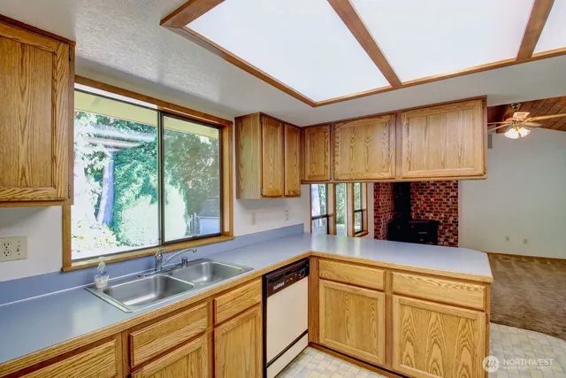 a kitchen with a sink and a large window