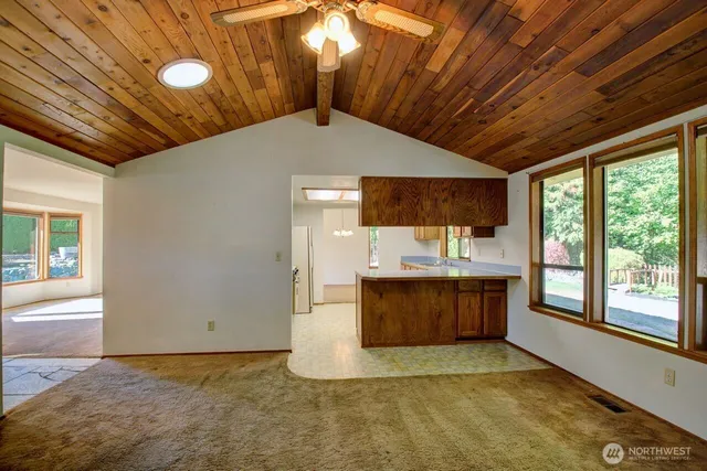 a view of an empty room with a kitchen