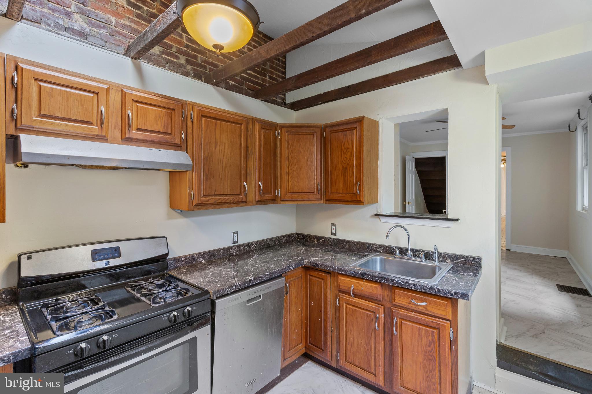 119 South Poppleton Street Baltimore, MD 21201 - Photo 11 of 27 a kitchen with granite countertop a stove and a sink