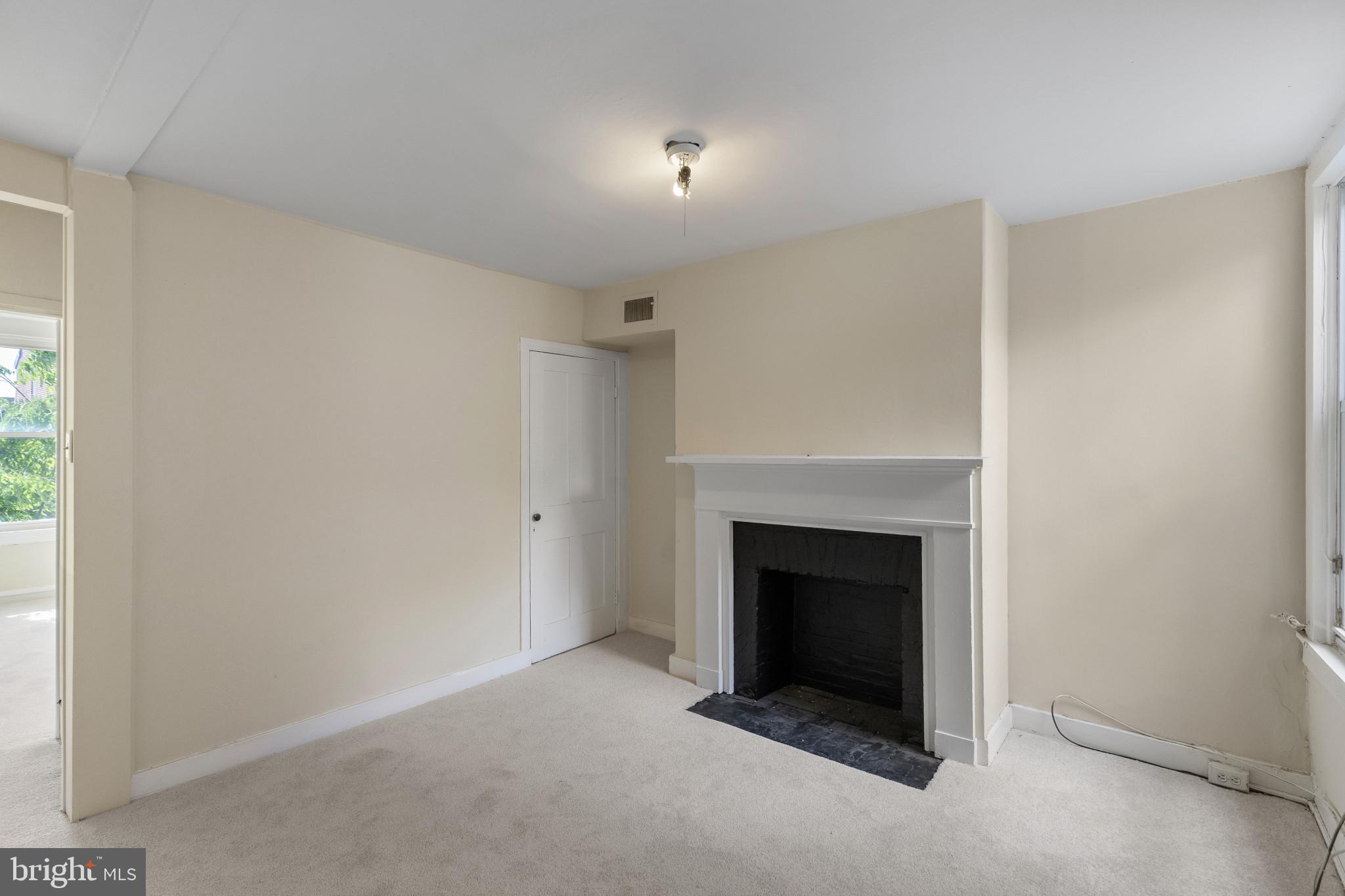 119 South Poppleton Street Baltimore, MD 21201 - Photo 15 of 27 a view of an empty room with a fireplace