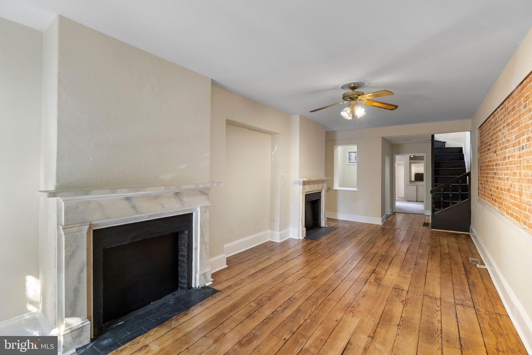 119 South Poppleton Street Baltimore, MD 21201 - Photo 4 of 27 a view of empty room with wooden floor and fireplace