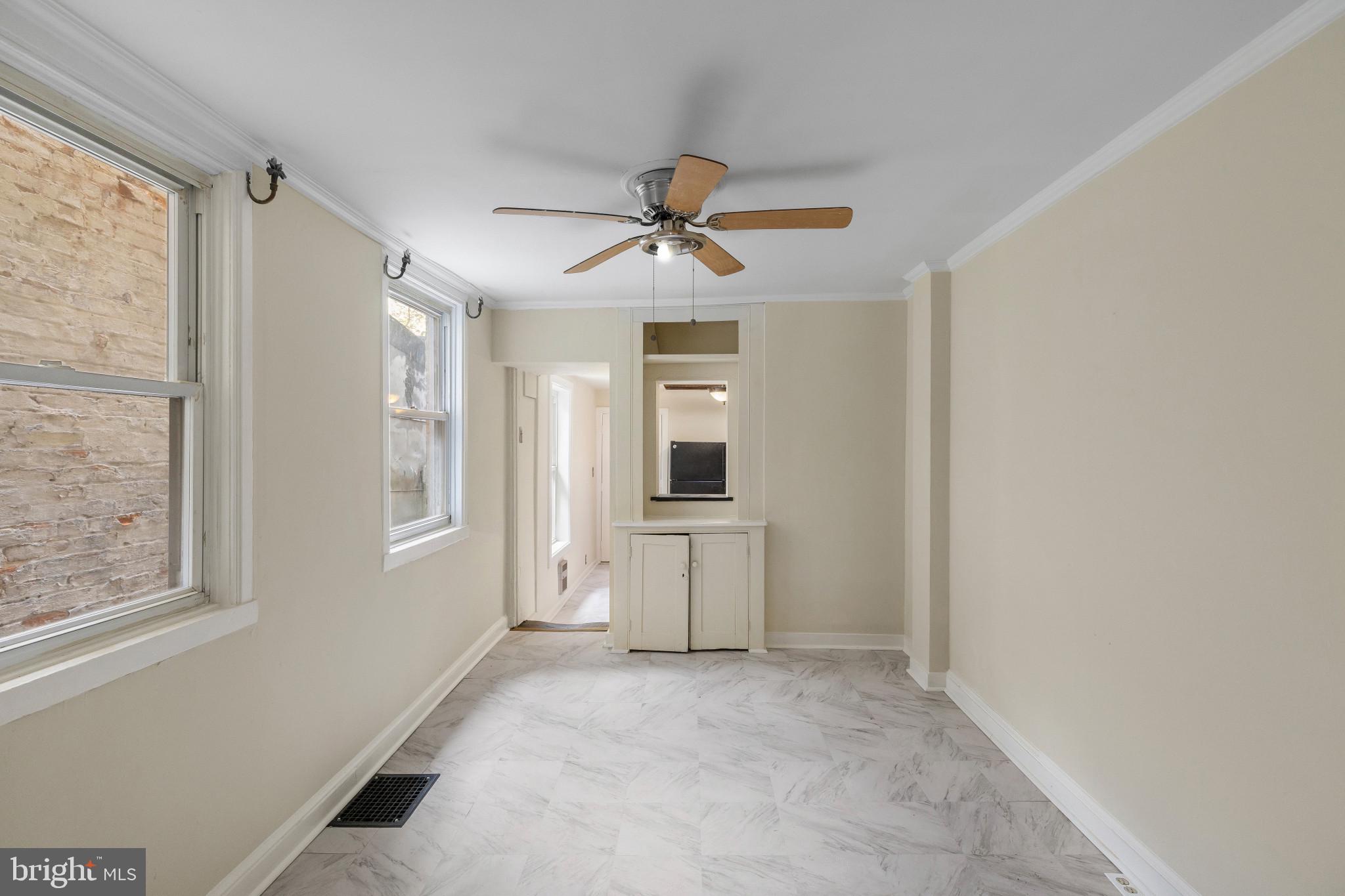 119 South Poppleton Street Baltimore, MD 21201 - Photo 8 of 27 a view of a livingroom with a chandelier fan and windows