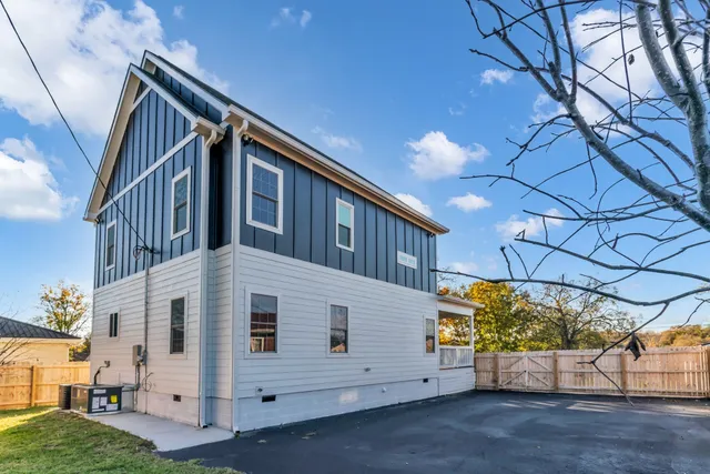 a view of a house with backyard and trees