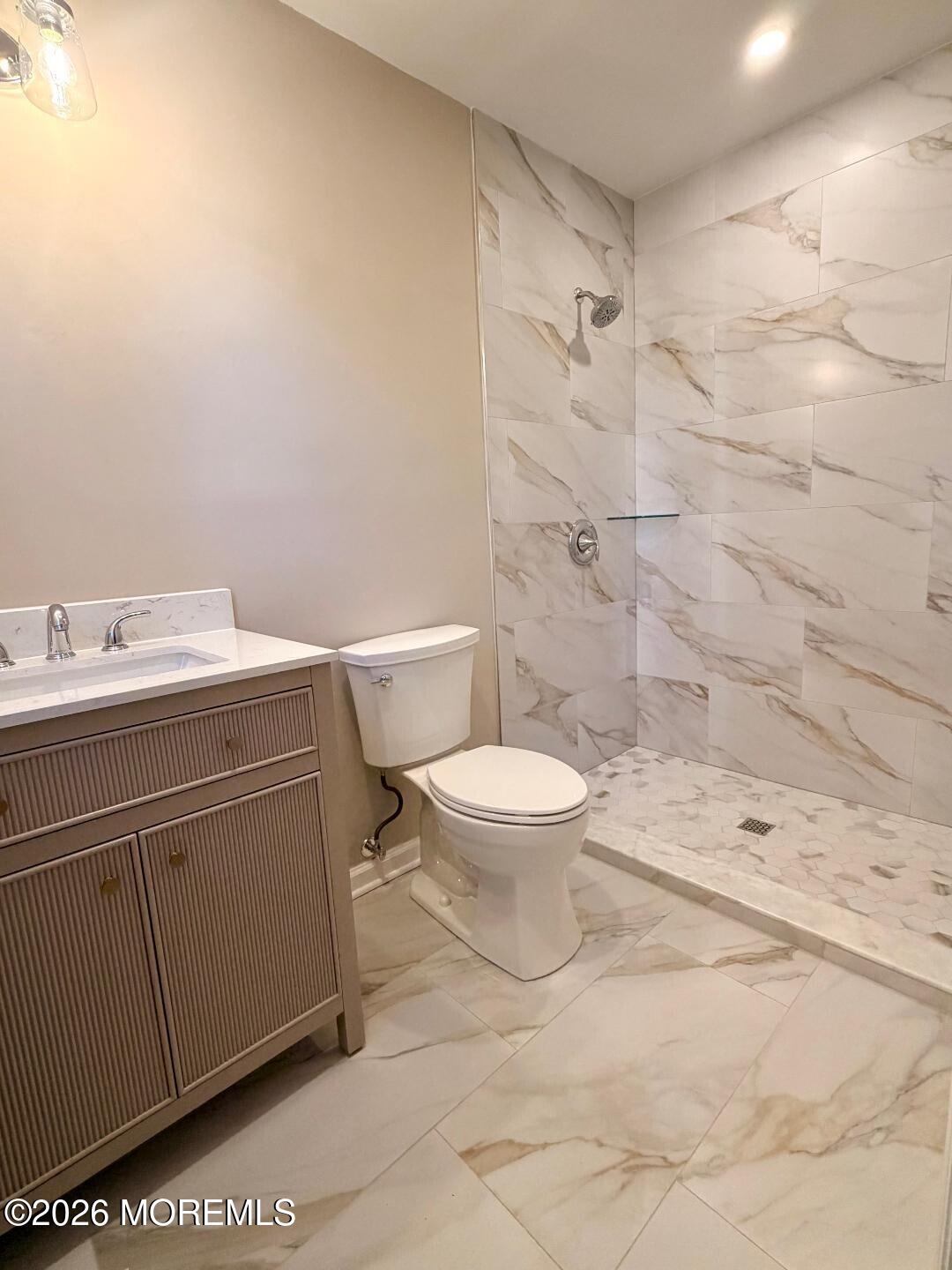 3 Gatley Close, Unit 1000 Freehold, NJ 07728 - Photo 17 of 24 a bathroom with a toilet sink vanity and shower