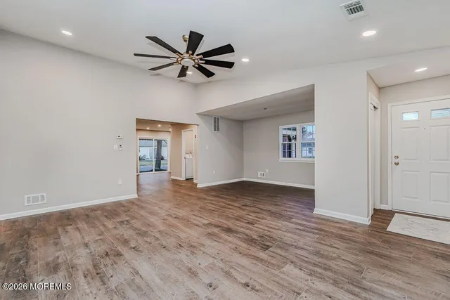 a view of a livingroom with a hardwood floor and a ceiling fan