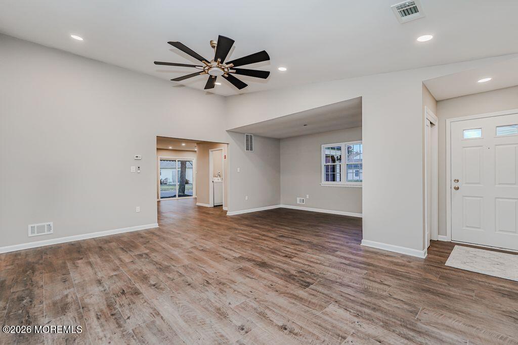 3 Gatley Close, Unit 1000 Freehold, NJ 07728 - Photo 2 of 24 a view of a livingroom with a hardwood floor and a ceiling fan