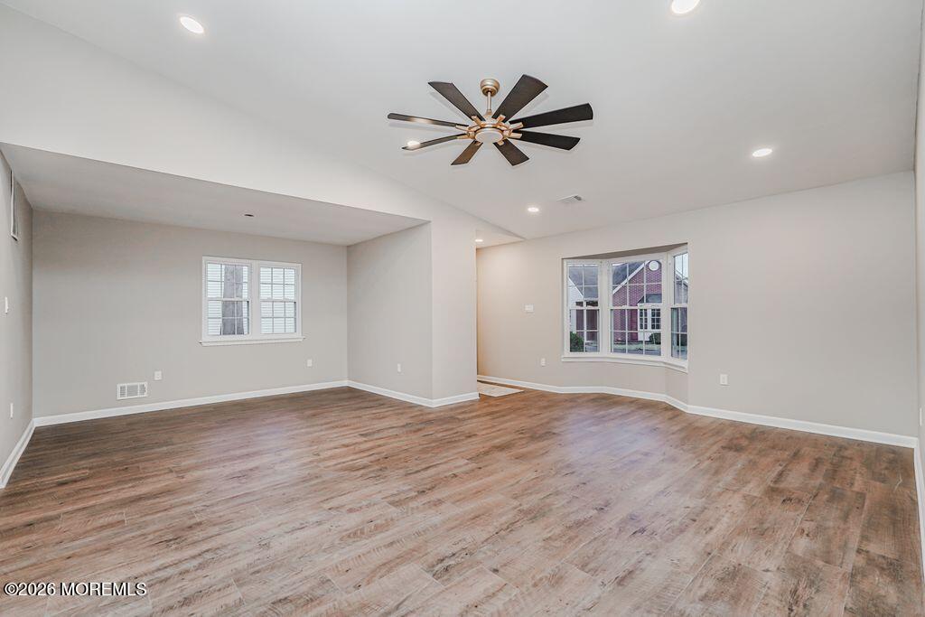 3 Gatley Close, Unit 1000 Freehold, NJ 07728 - Photo 3 of 24 a view of empty room with wooden floor and fan