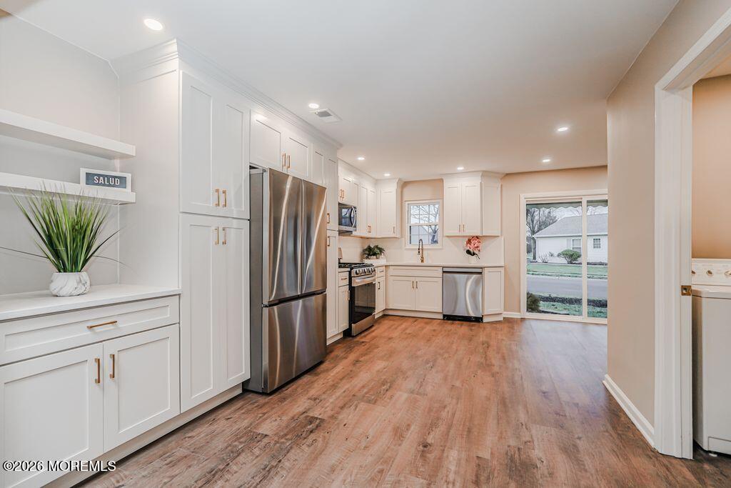3 Gatley Close, Unit 1000 Freehold, NJ 07728 - Photo 4 of 24 a kitchen with white cabinets and stainless steel appliances