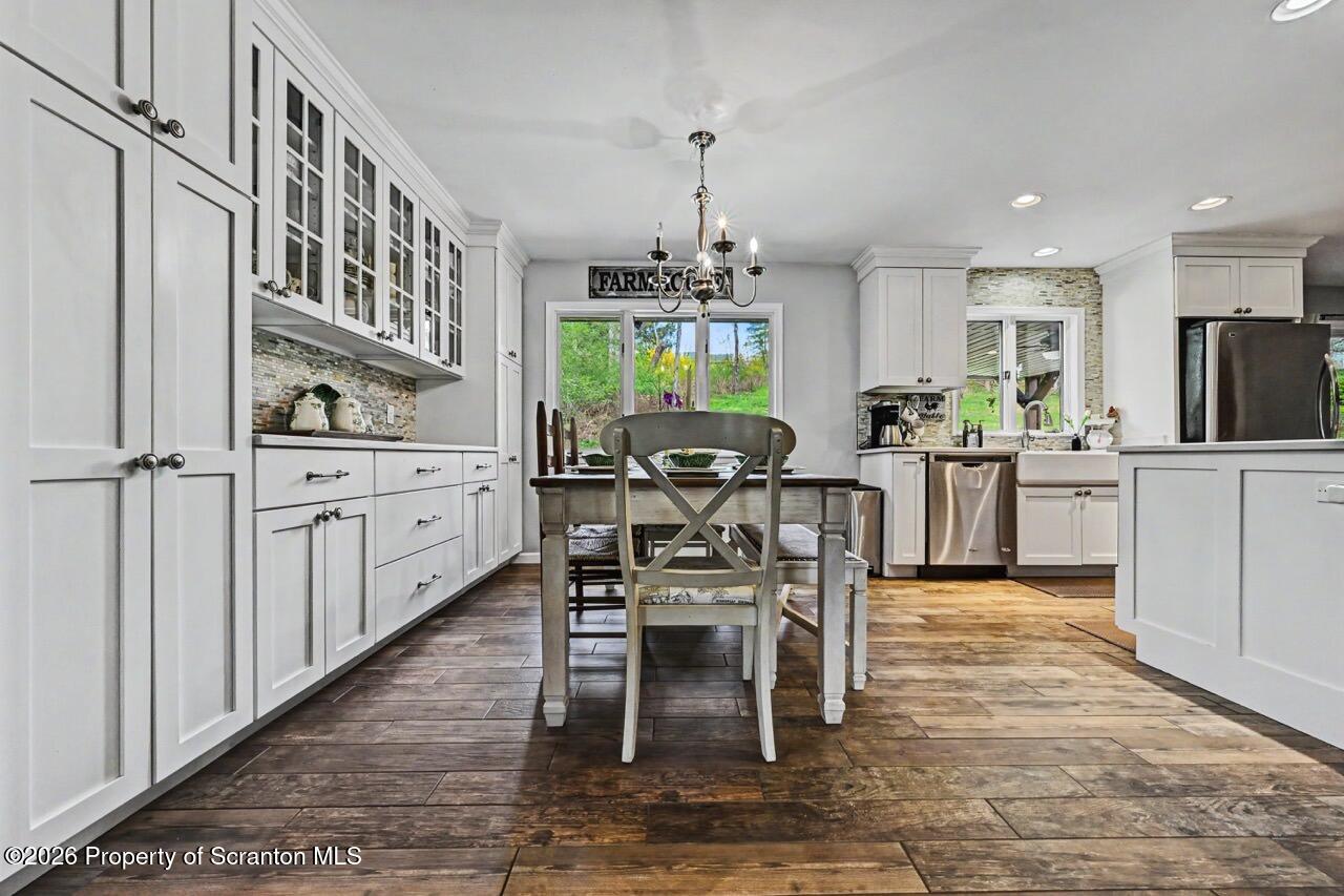 719 Scott Road Clarks Summit, PA 18411 - Photo 9 of 51 a dining room with furniture a chandelier and wooden floor