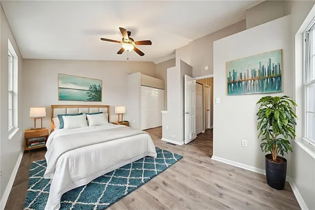 a bedroom with a bed and a potted plant