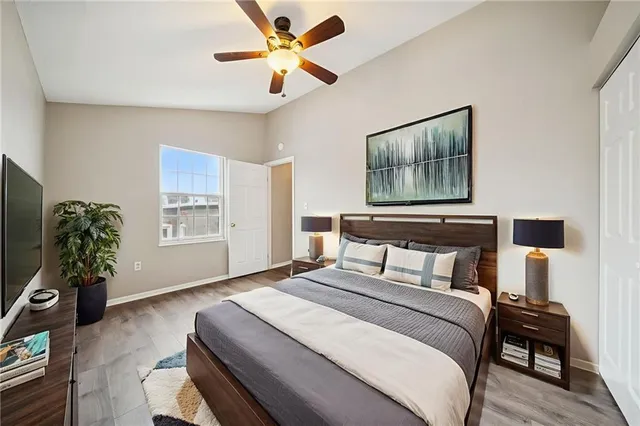 a bedroom with a bed chandelier and a window