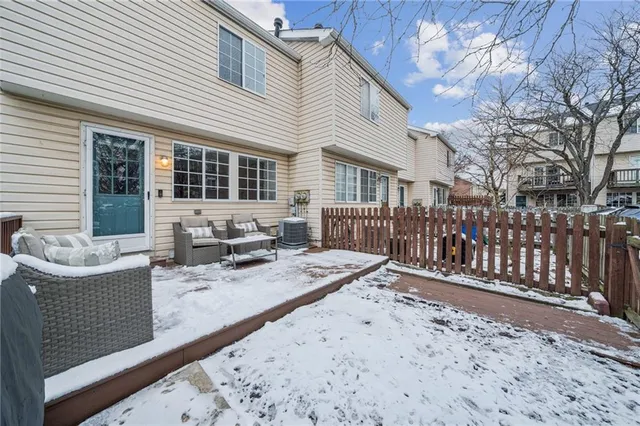 a view of a house with wooden deck and furniture