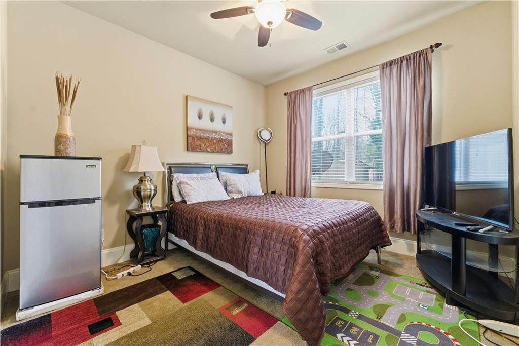 3411 Lynne Road Powder Springs, GA 30127 - Photo 17 of 27 a bedroom with a bed and a flat screen tv