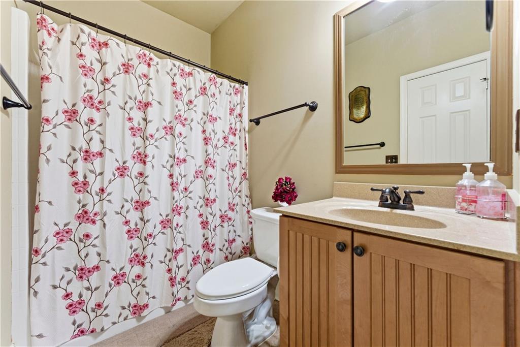 3411 Lynne Road Powder Springs, GA 30127 - Photo 18 of 27 a bathroom with a sink toilet and a mirror