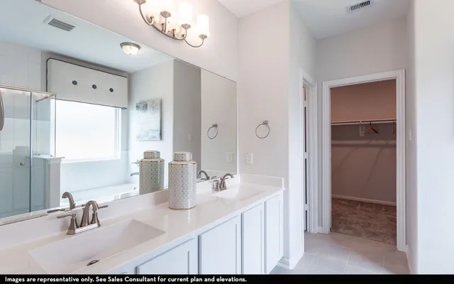 a bathroom with a sink double vanity and a mirror