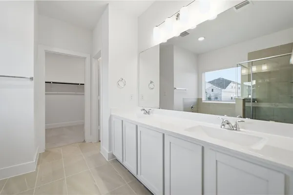 a bathroom with a double vanity sink mirror and double